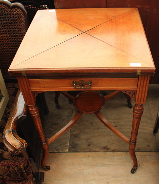 Appraisal: A VICTORIAN MAHOGANY WALNUT ENVELOPE CARD TABLE with single frieze