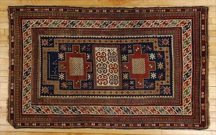 Appraisal: CAUCASIAN RUG The cobalt field with central ivory rectangle and