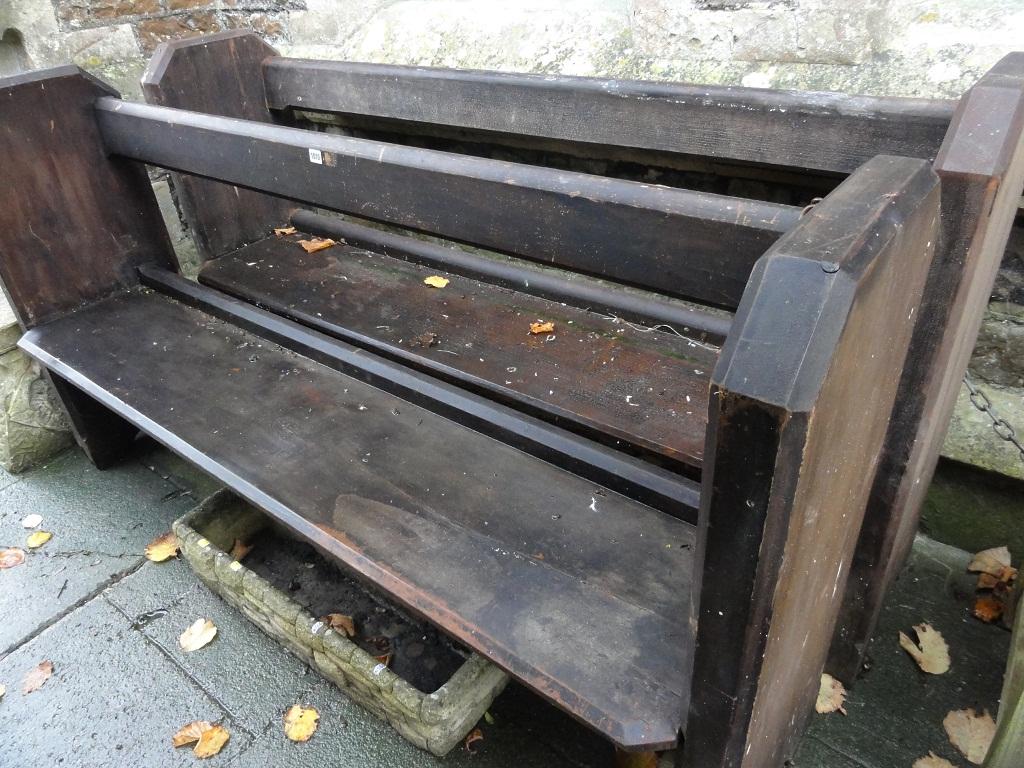 Appraisal: A pair of stained pine church pews with open rail