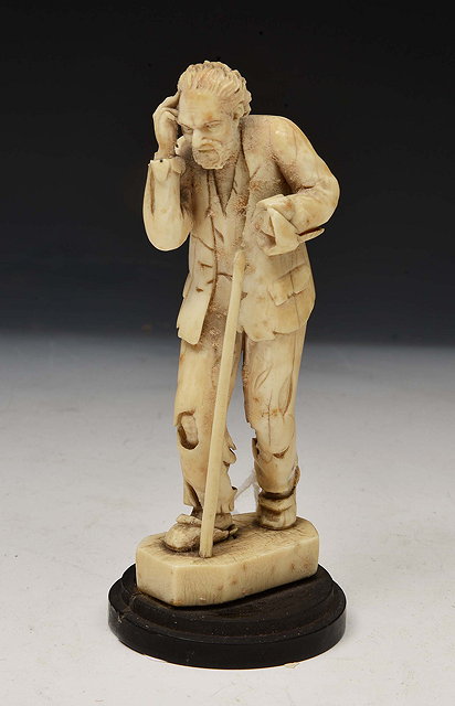 Appraisal: AN ANTIQUE CARVED IVORY FIGURE of an old man with