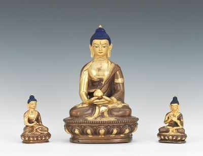 Appraisal: Three Sino-Tibetan Gilt Bronze Seated Buddha Figurines The meditating figures