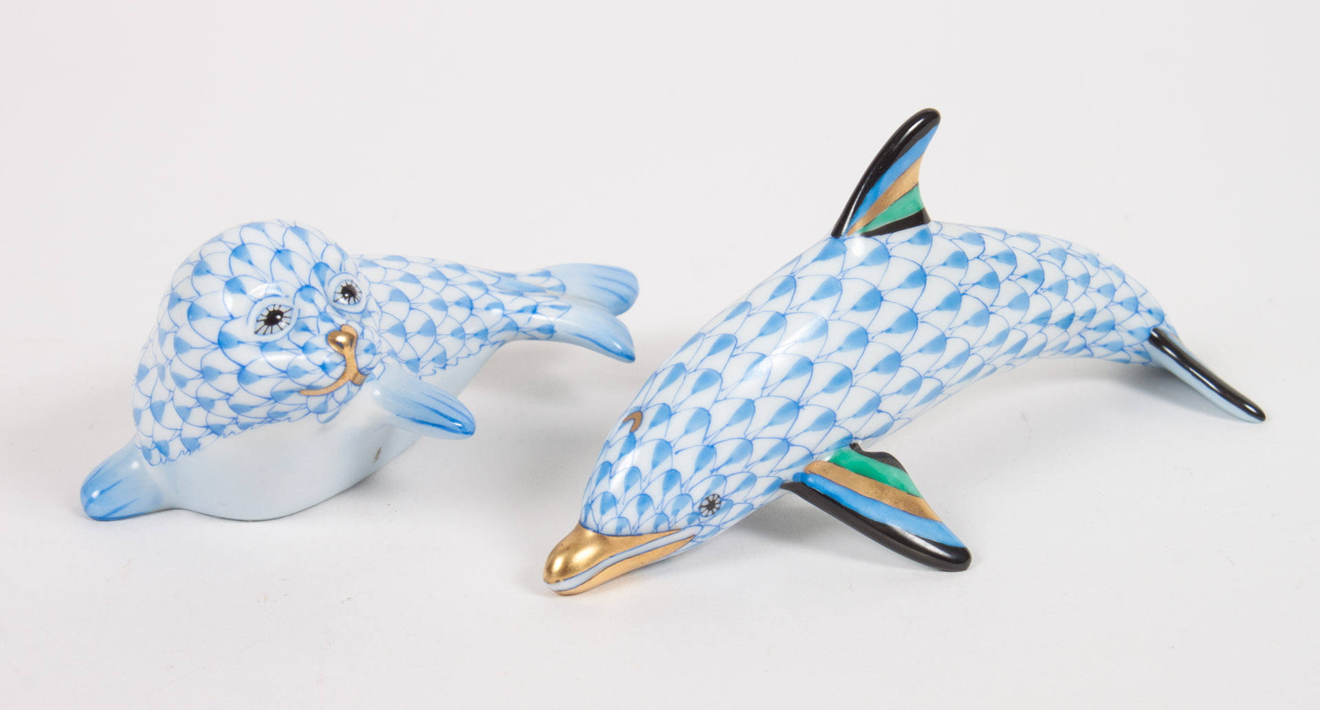 Appraisal: Herend porcelain dolphin and seal blue fishnet pattern parcel-gilt highlights