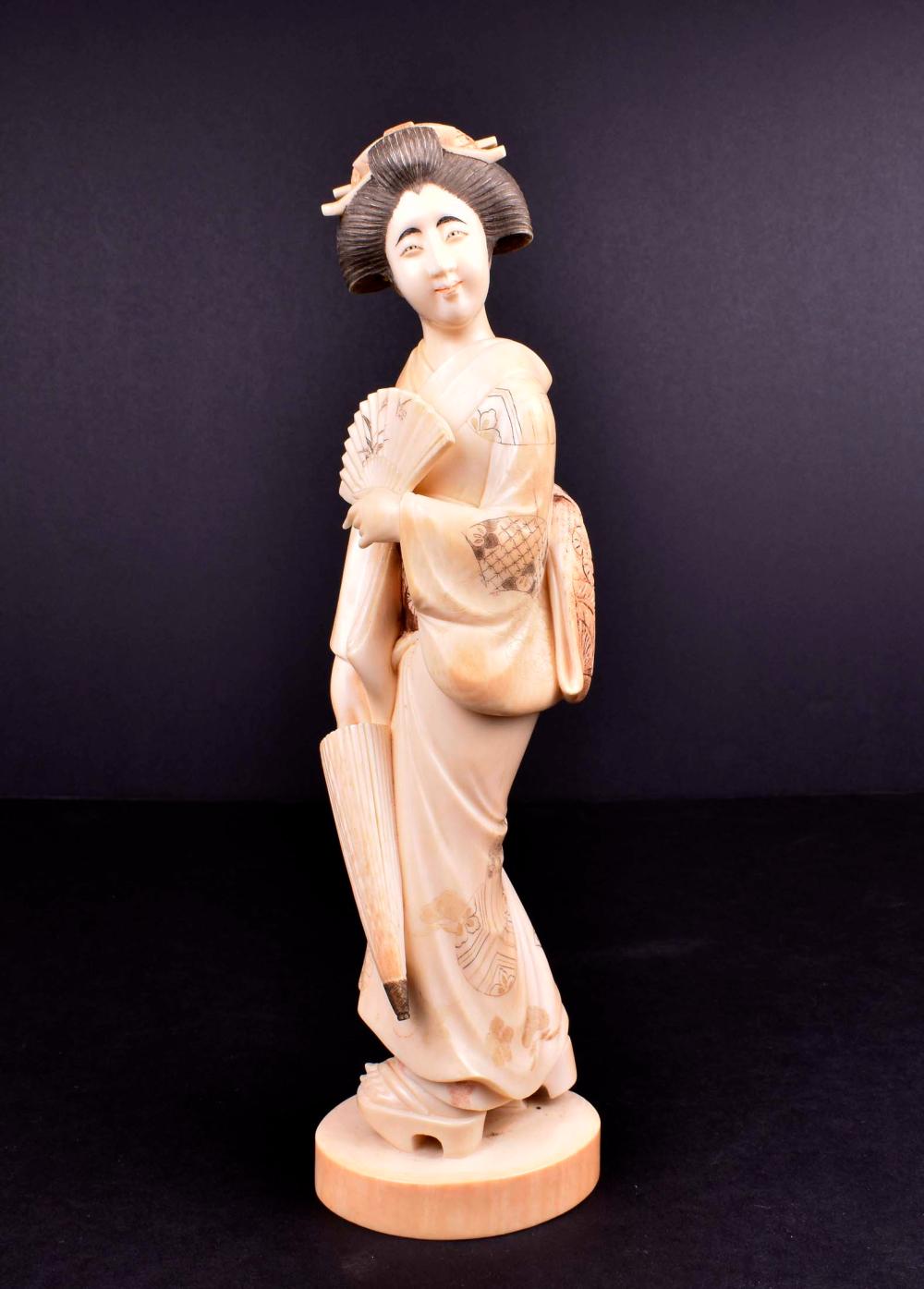 Appraisal: JAPANESE OKIMONO OF A GEISHA WITH UMBRELLAMeiji Period Signed The