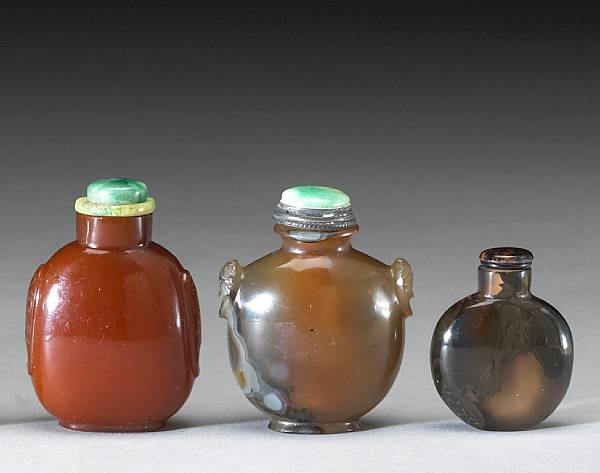 Appraisal: Three agate snuff bottles One of translucent dark caramel hue