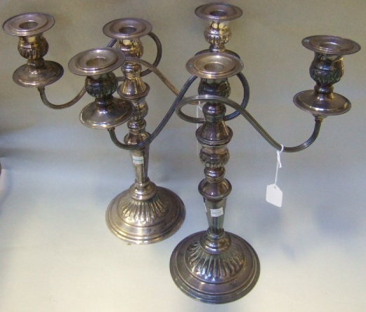 Appraisal: A pair of plated three light candelabra each with partly