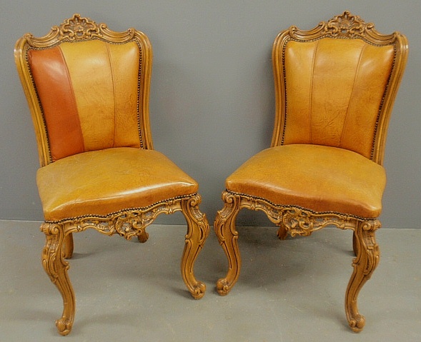 Appraisal: - Pair of French carved fruitwood and leather side chairs