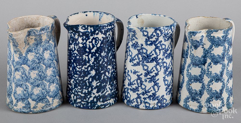 Appraisal: Four blue spongeware pitchers th c Four blue spongeware pitchers