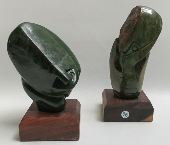 Appraisal: TWO AFRICAN CARVED STONE SCULPTURES with wood bases each depicting