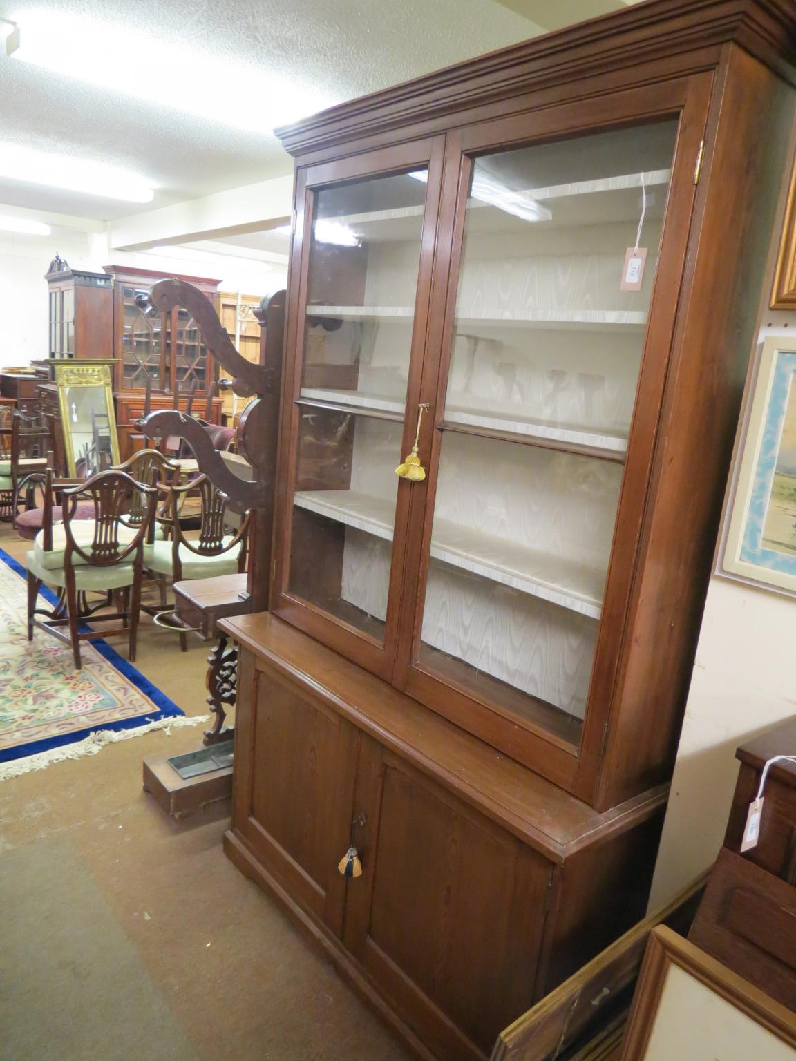 Appraisal: A Victorian waxed pine tall bookcase pair of glazed doors