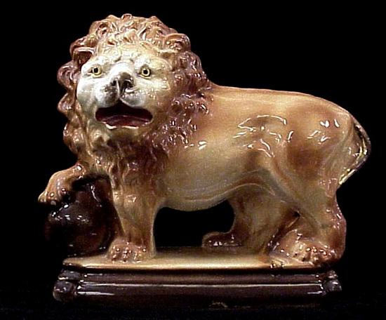 Appraisal: Standing Staffordshire lion with one paw on ball some craquelure