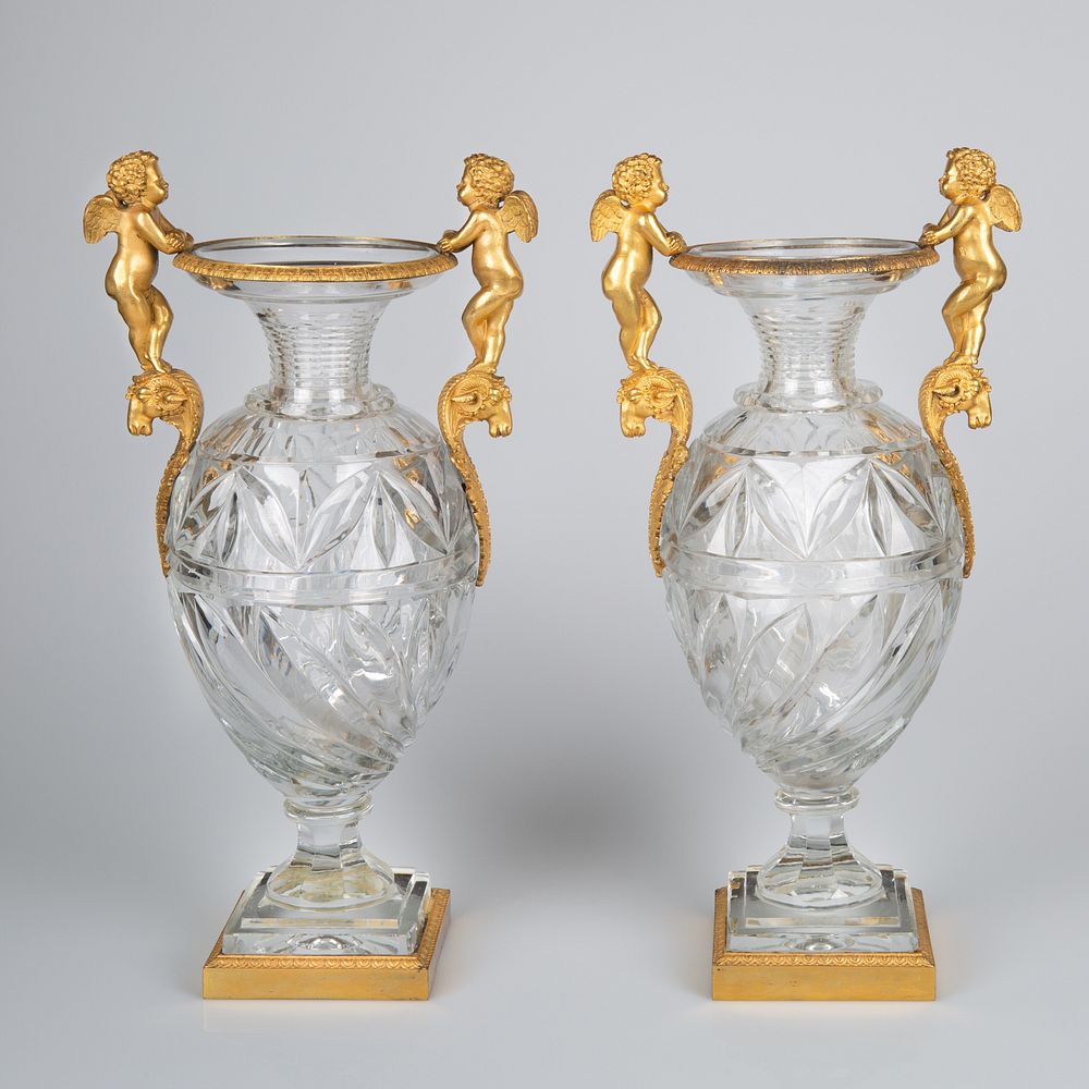 Appraisal: A PAIR OF FRENCH OR RUSSIAN ORMOLU-MOUNTED TWO-HANDLED CRYSTAL VASES