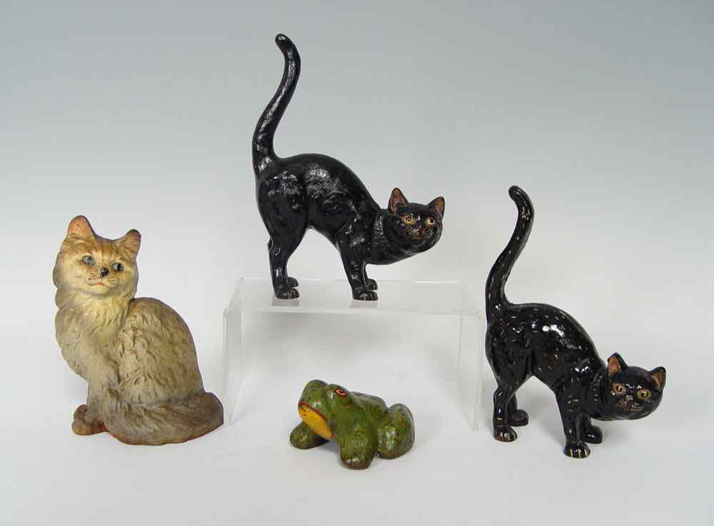 Appraisal: CAST IRON DOORSTOPS- CATS AND A FROG Black cats are