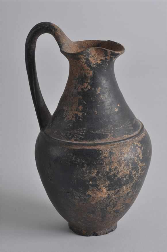 Appraisal: ETRUSCAN BUCCHERO POTTERY TREFOIL OINOCHOE With a trefoil shaped mouth