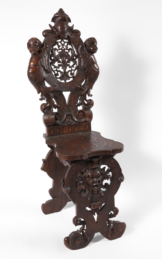 Appraisal: ITALIAN BAROQUE STYLE WALNUT CARVED HALL CHAIR Profusely carved in