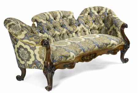 Appraisal: A Victorian carved walnut and upholstered settee covered in blue