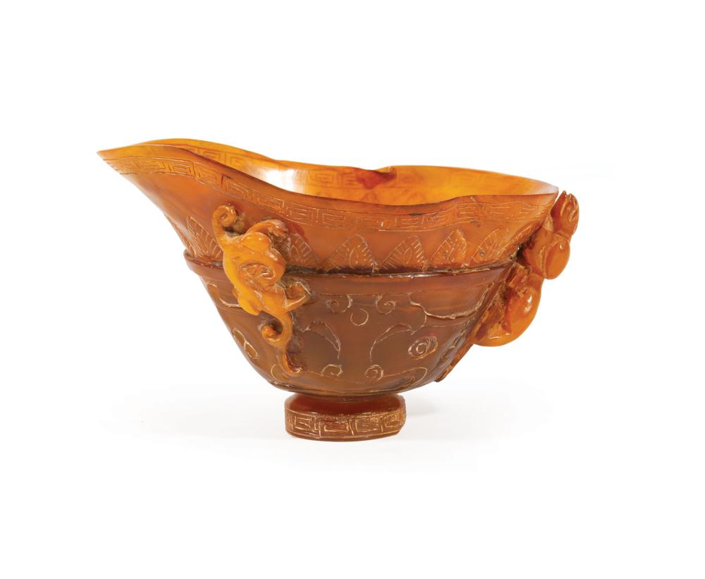 Appraisal: Chinese Horn Libation Cup relief-carved with qilong dragons and petal