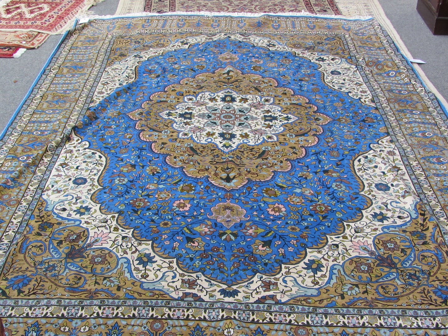 Appraisal: A silk carpet of Persian design the vivid indigo field