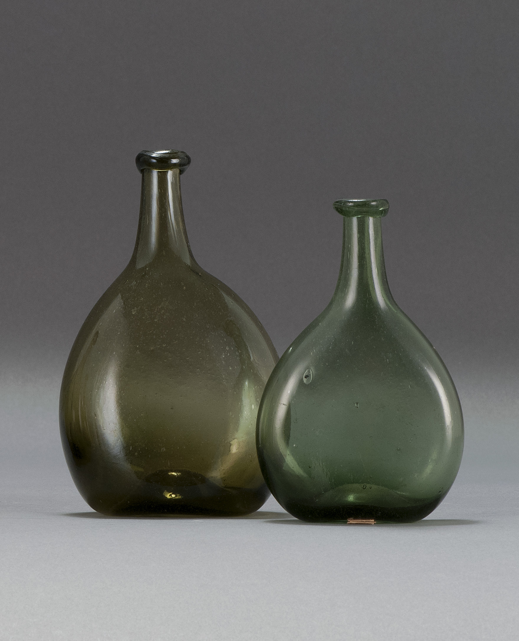 Appraisal: TWO FREE-BLOWN GLASS CHESTNUT FLASKS Early th CenturyIn olive green