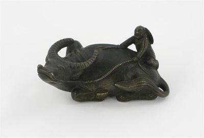 Appraisal: A small Chinese bronze model of a boy climbing upon