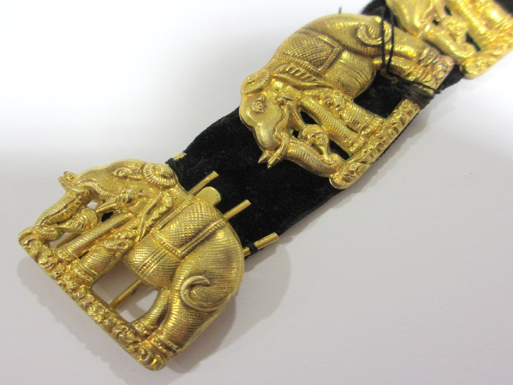 Appraisal: An Indian bracelet with yellow metal embossed elephants sewn to