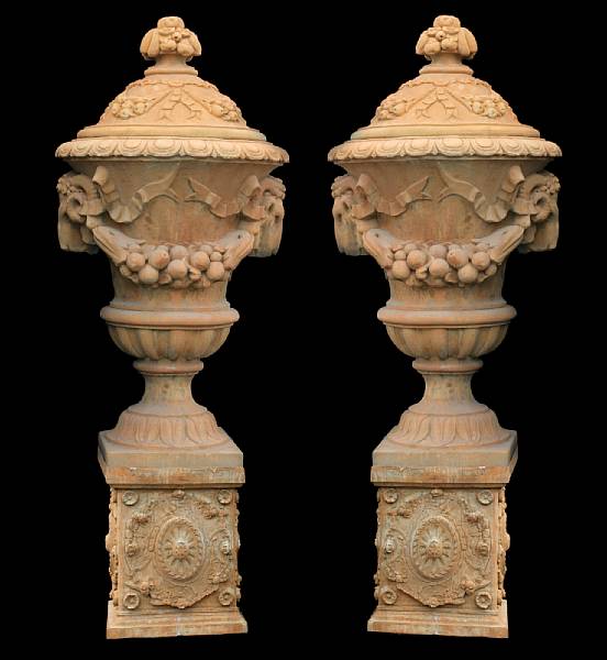 Appraisal: A pair of stone covered urns on pedestals modern The