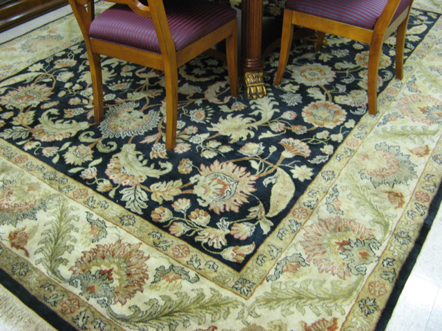 Appraisal: HAND KNOTTED ORIENTAL CARPET Pakistani-Persian overall floral design on black