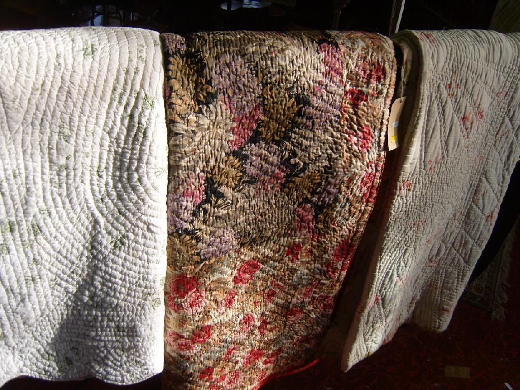 Appraisal: A collection of three quilted bedcovers with various floral detail