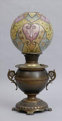 Appraisal: AMERICAN GILT-METAL OIL LAMP WITH ART GLASS SHADE The -handled