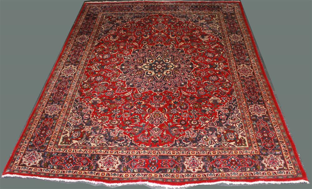 Appraisal: HANDWOVEN HERIZ WOOL RUG having a central medallion on a