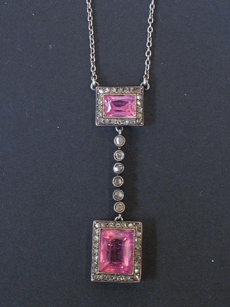 Appraisal: AN ART DECO DROP PENDANT set with two baguette-cut pink