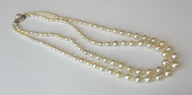 Appraisal: A two row pearl and cultured pearl necklace graduating from