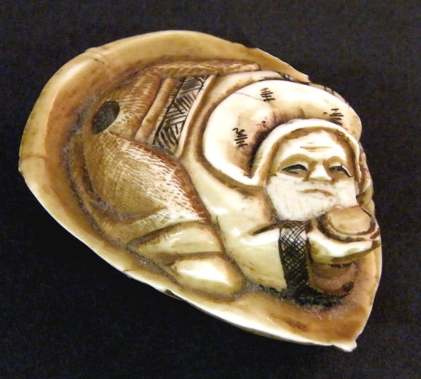 Appraisal: Japanese ivory Netsuke modelled with a crouching bearded gentleman upon