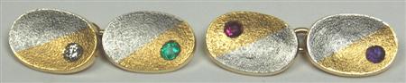 Appraisal: A pair of multi-gem set acrostic cufflinks with two-coloured oval