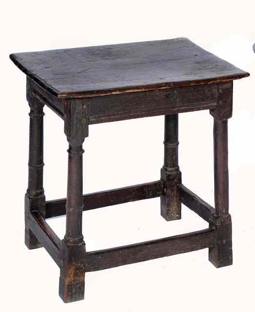 Appraisal: AN OLD OAK CIRCULAR 'CRICKET' TABLE on three splay legs