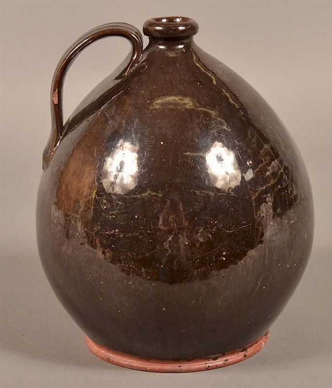 Appraisal: Manganese Glazed Redware Bulbous Form Jug th Century Manganese Glazed