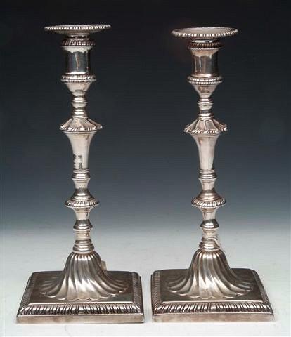 Appraisal: A PAIR OF GEORGE III CAST SILVER CANDLESTICKS on square