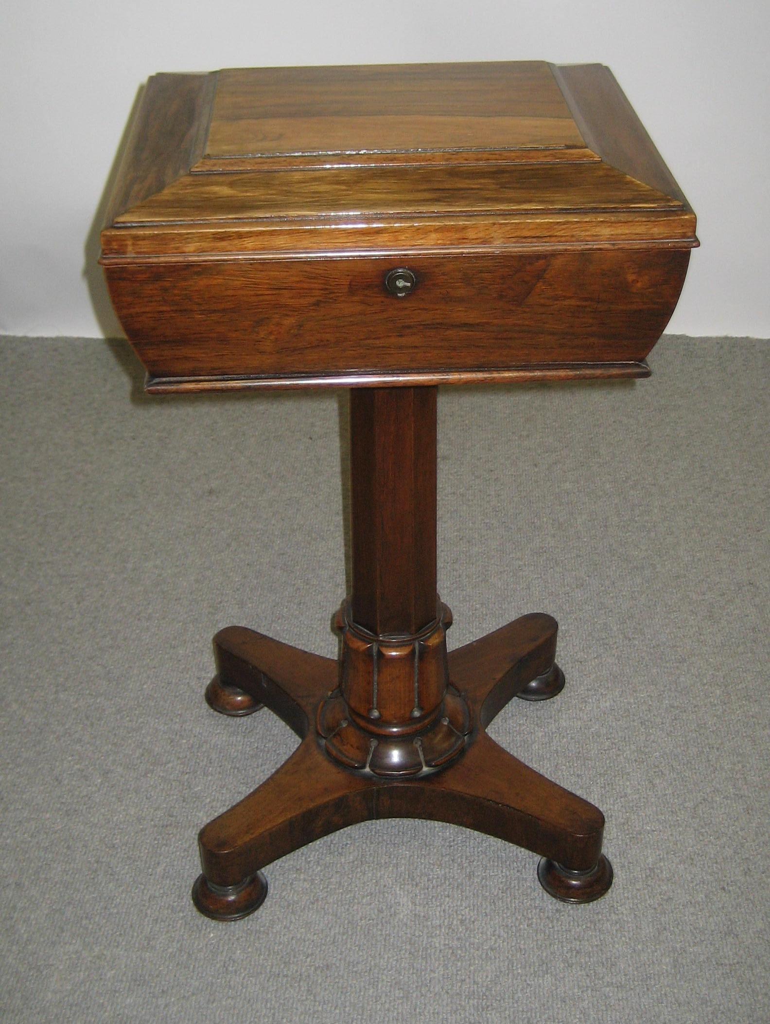 Appraisal: A WILLIAM IV ROSEWOOD TEAPOY the oblong sarcophagus shaped top