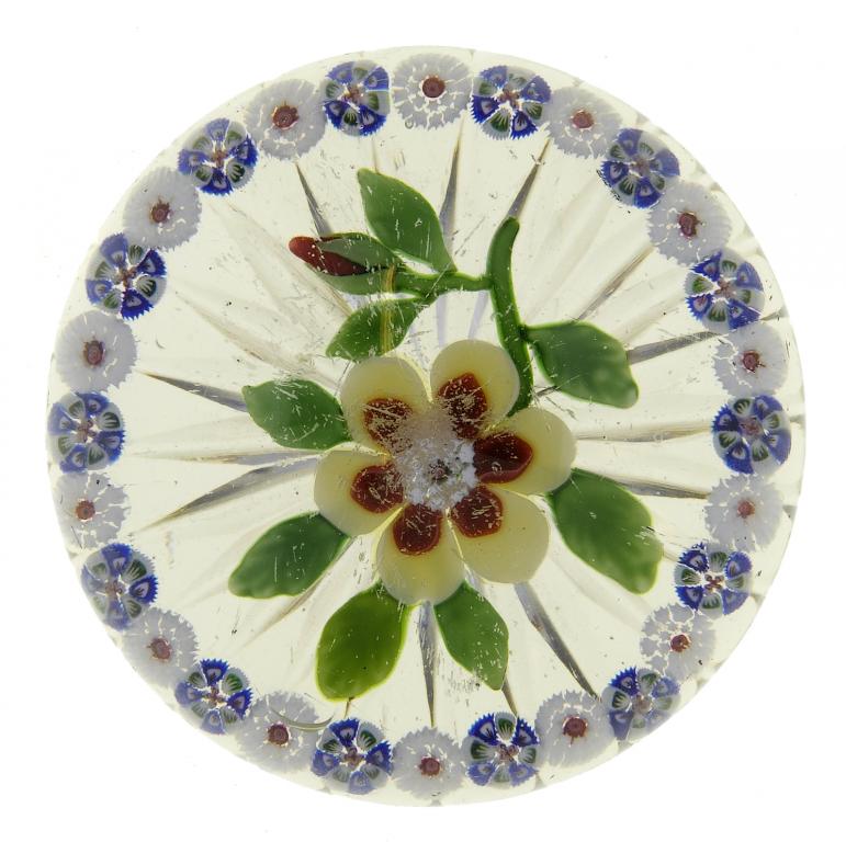 Appraisal: A BACCARAT GARLANDED FLOWER PAPERWEIGHT the yellow and red flower