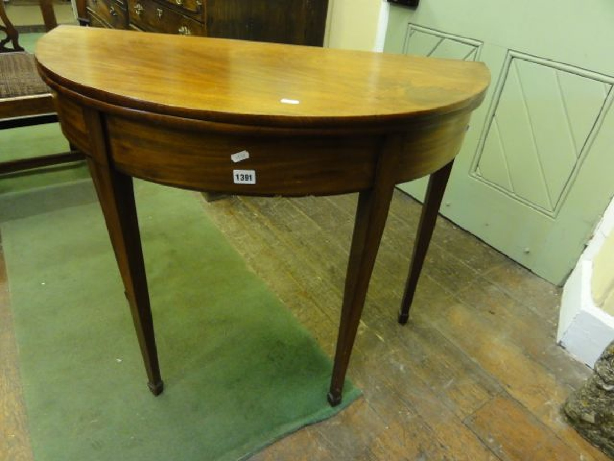 Appraisal: A Georgian mahogany demi-lune fold over top tea table and