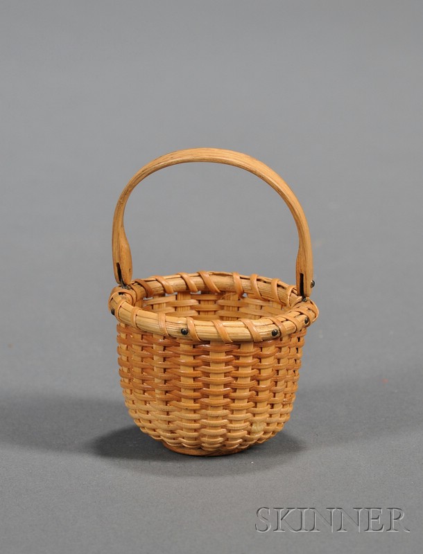 Appraisal: Miniature Nantucket Basket America th century round woven cane basket