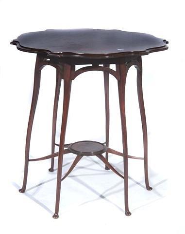 Appraisal: AN EDWARDIAN MAHOGANY CENTRE TABLE with shaped top on six