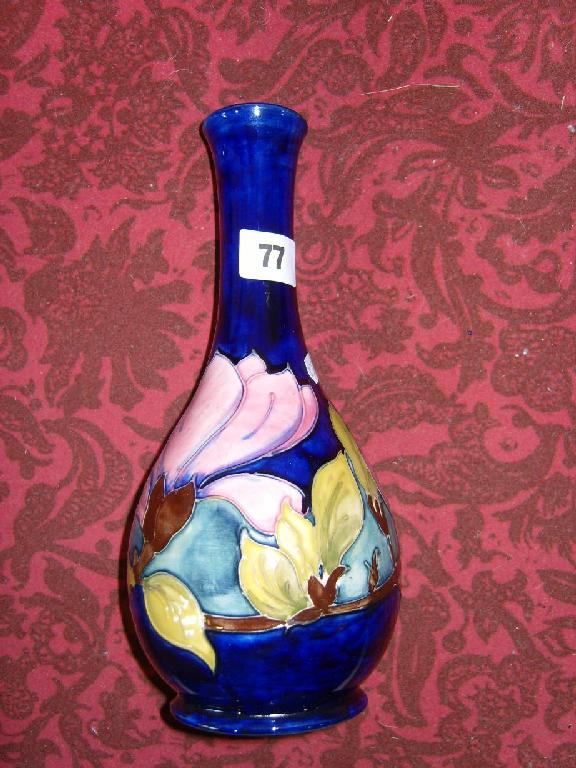 Appraisal: A blue ground Moorcroft vase with drawn neck and painted