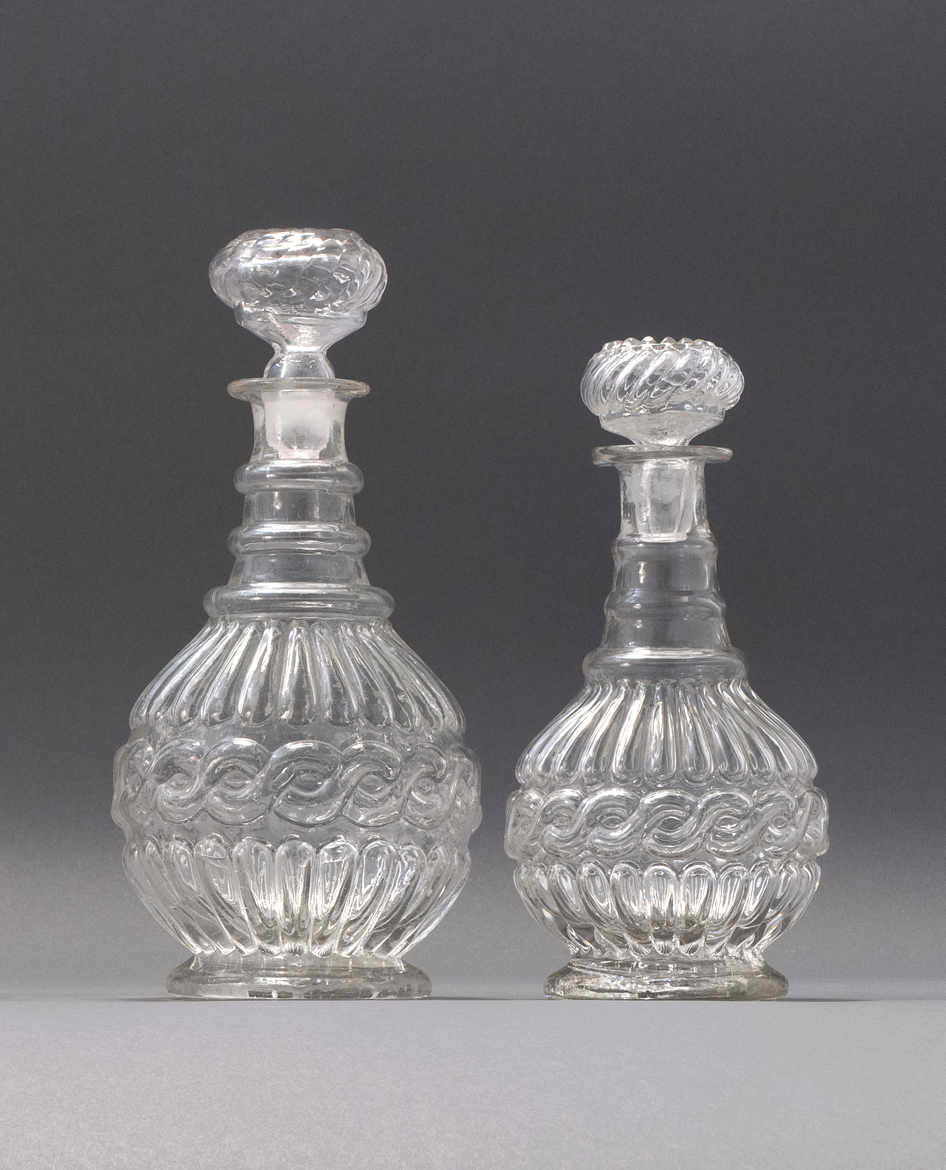 Appraisal: TWO CLEAR GLASS BLOWN -MOLD DECANTERS Second Quarter of the