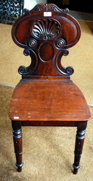 Appraisal: A William IV mahogany hall chair with carved shell detail