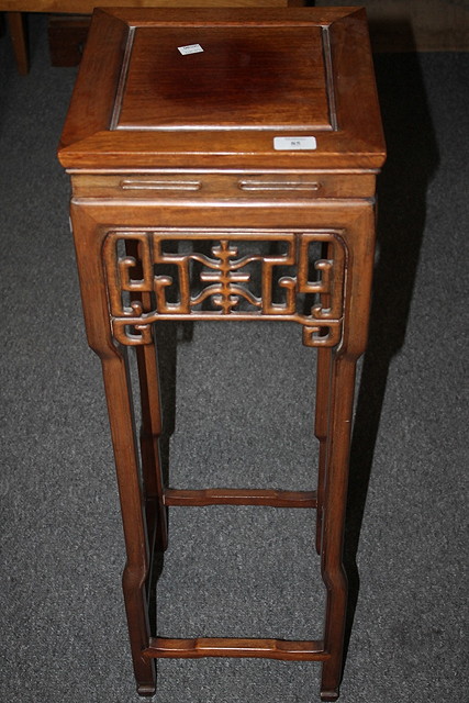 Appraisal: A CHINESE HARDWOOD SQUARE TOP URN STAND with fretwork sides