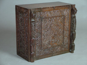 Appraisal: An Indian mahogany carved cabinet the top above three foliate