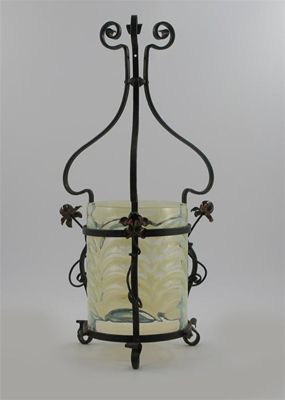 Appraisal: An Arts and Crafts wrought iron and copper mounted vaseline