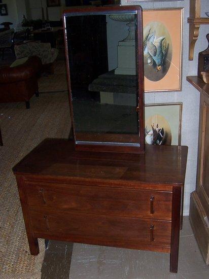 Appraisal: A mahogany dressing table by Gordon Russell with rectangular frameless