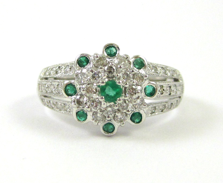 Appraisal: FOURTEEN KARAT WHITE GOLD EMERALD AND DIAMOND RING having nine