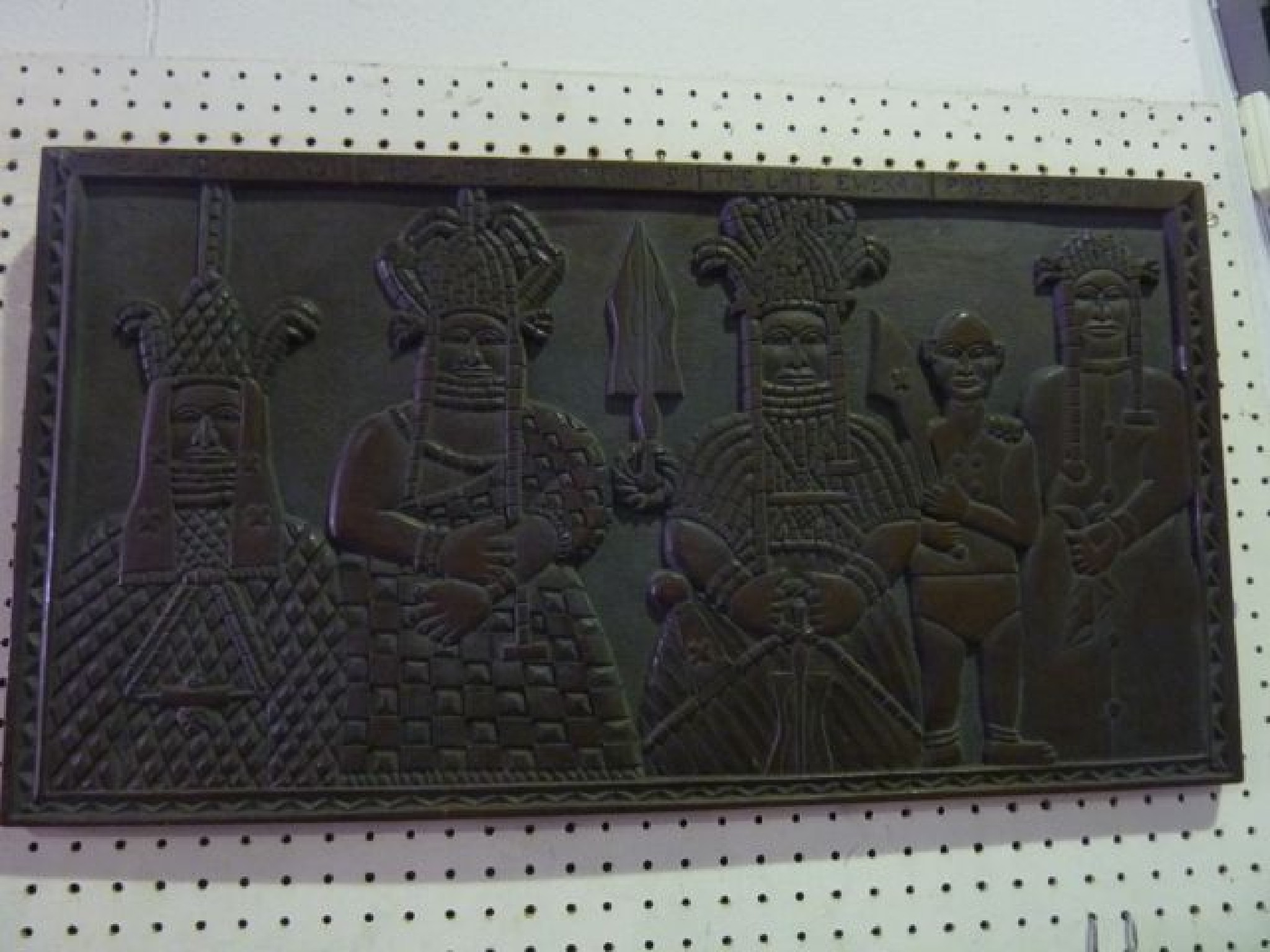 Appraisal: A Beninese Nigerian carved timber panel of rectangular form depicting